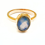 Labradorite faceted oval in gold ring