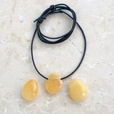 Calcite orange tumbled pendant with holes
